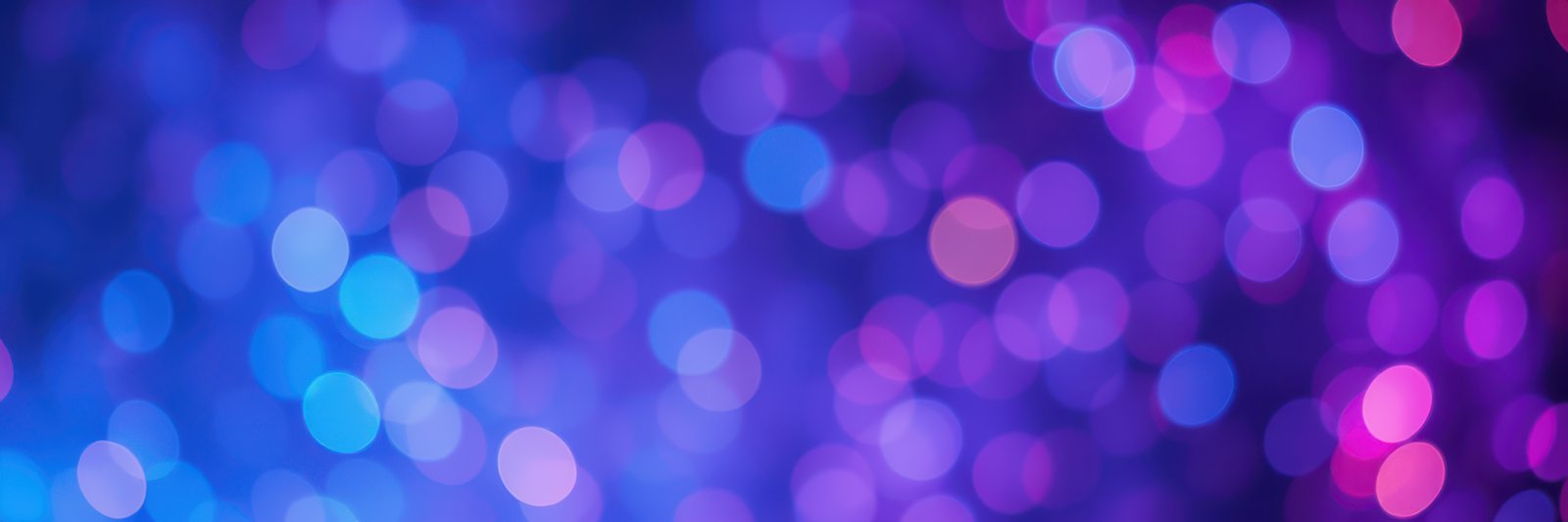 Colorful bokeh lights create a vibrant background suitable for festive occasions and celebrations